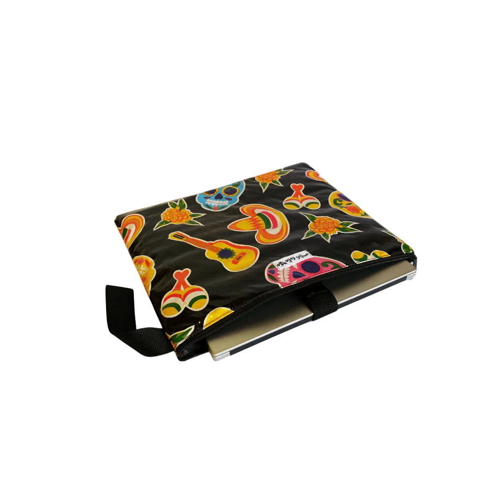Black laptop sleeve with colorful Day of the Dead skulls, guitars, maracas, and flowers pattern