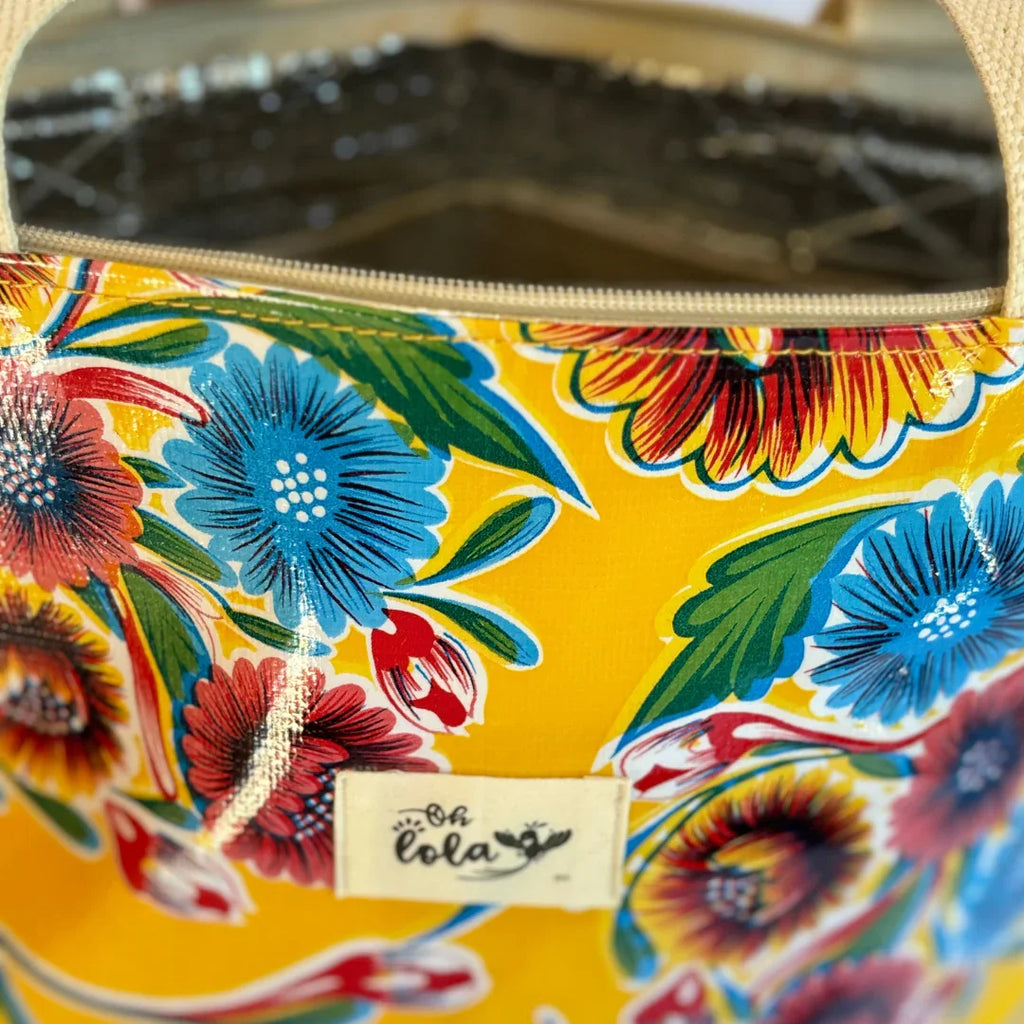 Close-up of a vibrant yellow floral patterned bag with a zipper and Oh Lola brand label