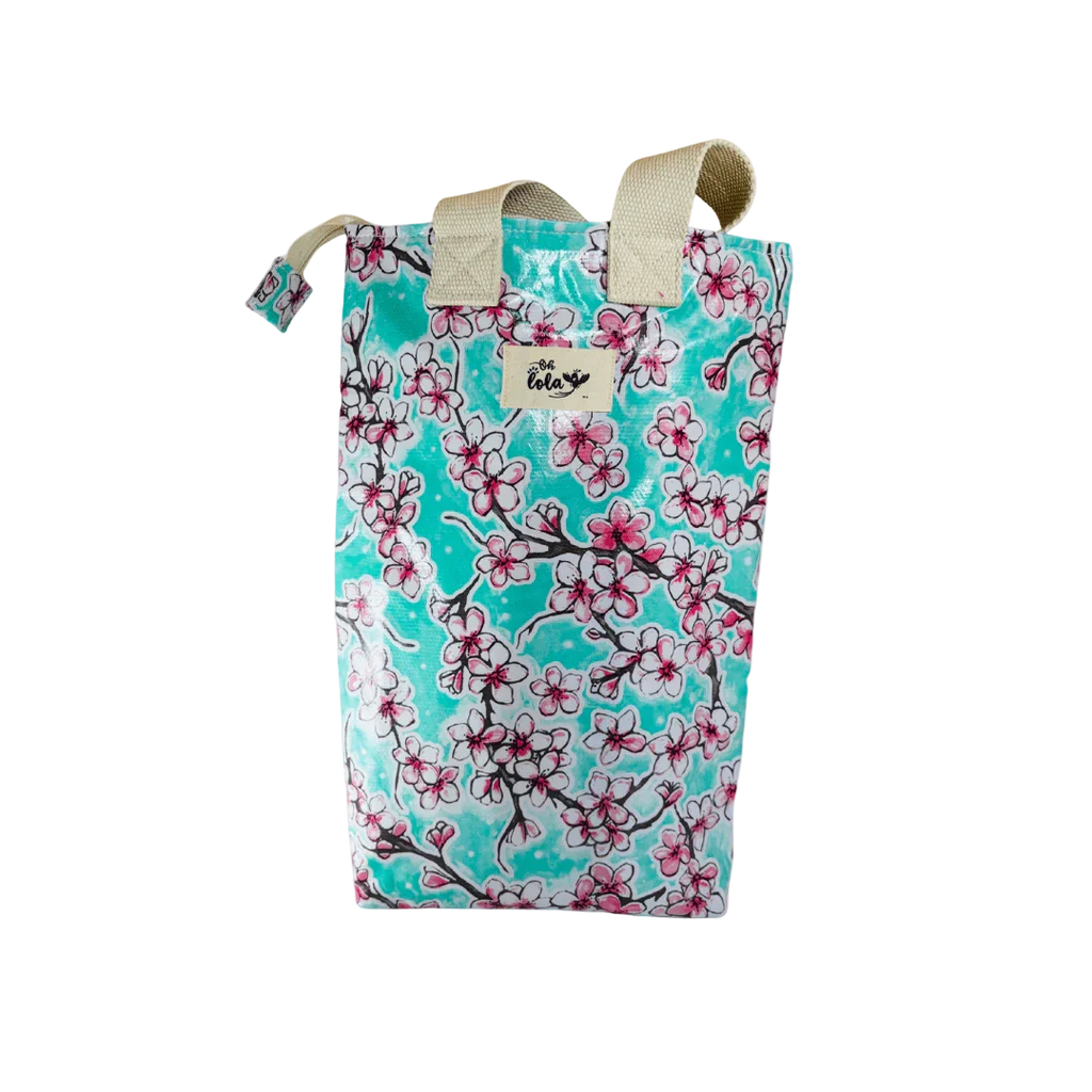 Reusable turquoise tote bag with pink and white cherry blossom print and cream handles