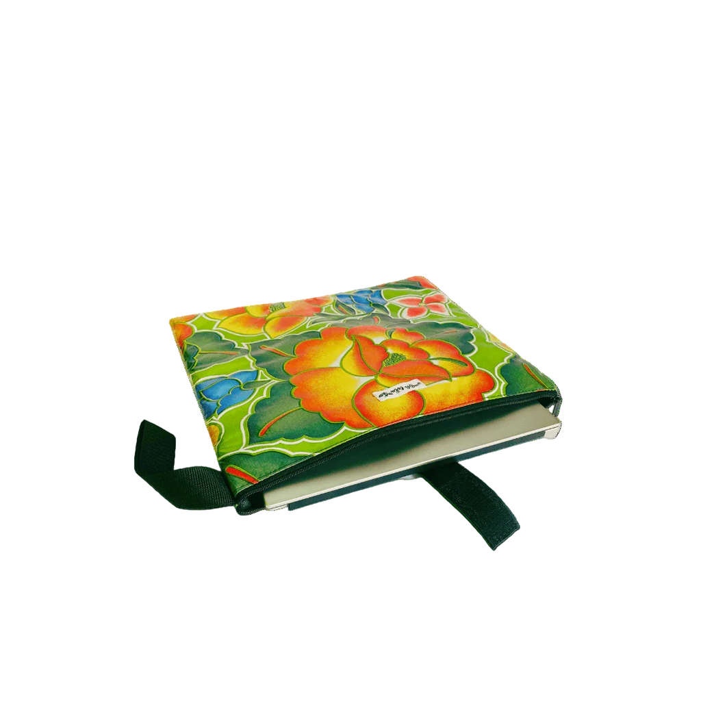 Colorful floral fabric book cover with yellow, green, blue, and orange flowers and a green strap