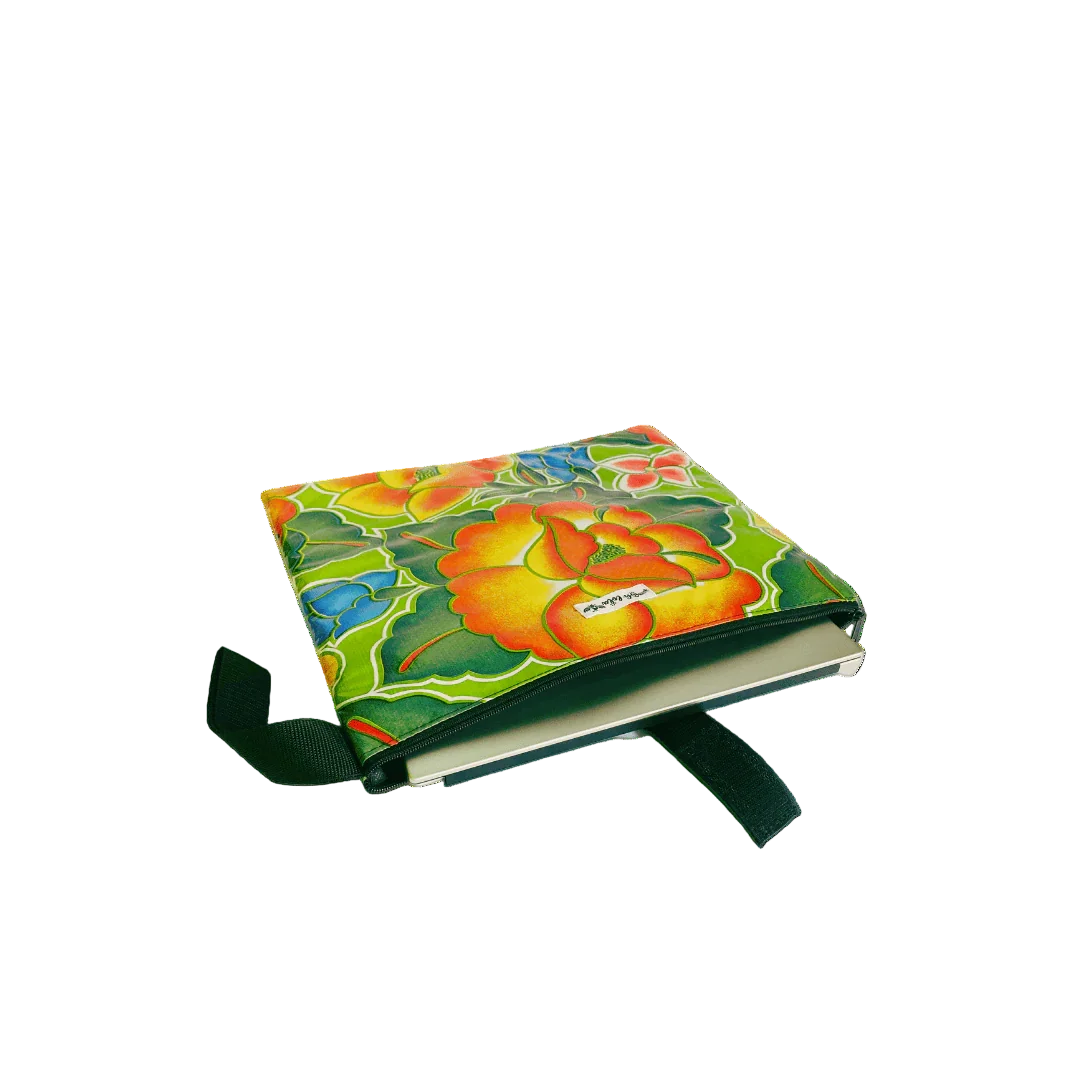 Colorful floral fabric book cover with yellow, green, blue, and orange flowers and a green strap