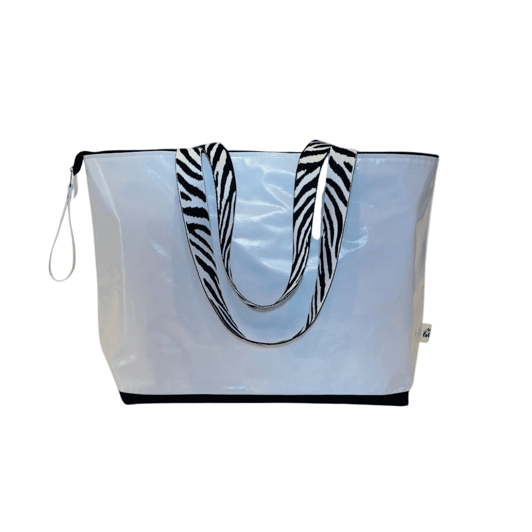 Clear tote bag with zebra pattern handles on a white background