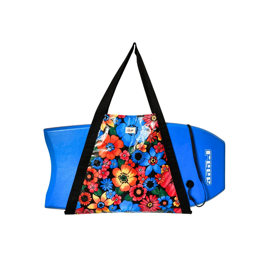 Blue foam kickboard with vibrant floral-patterned waterproof bag and black straps