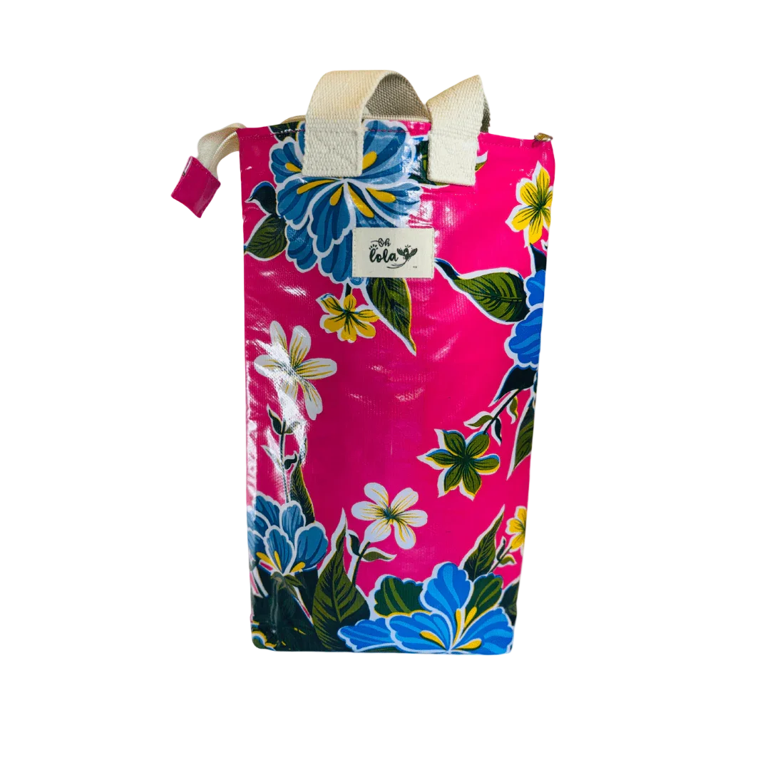 Bright pink floral tote bag with blue, yellow, and white flowers and white fabric handles