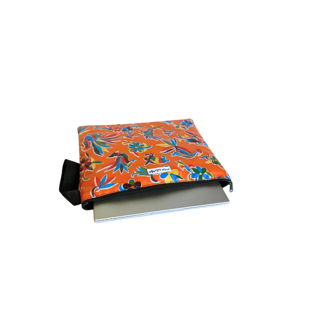 Orange floral-patterned pouch with black zipper partially unzipped, containing a silver laptop