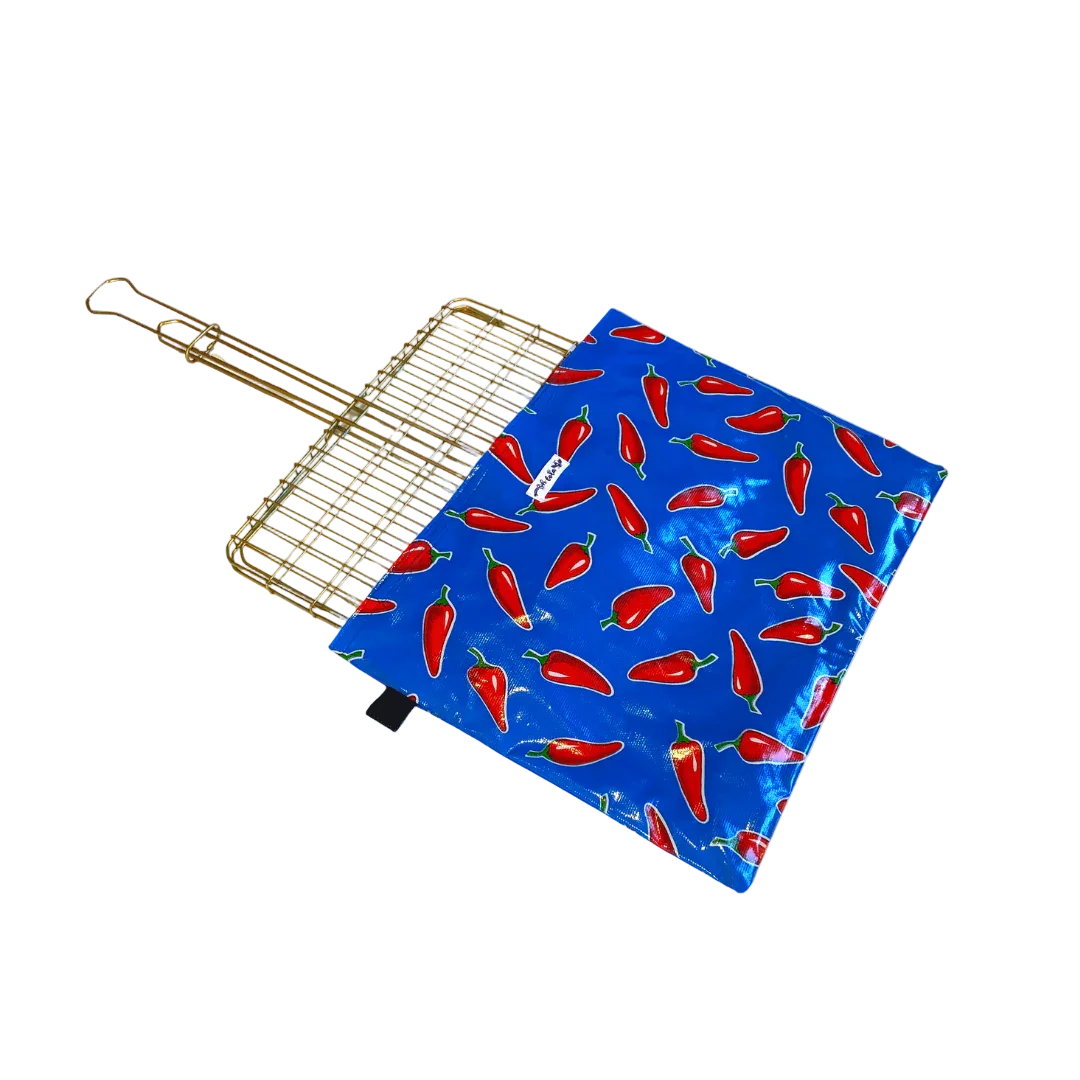 gold metal grill basket with blue chili pepper print grilling mat