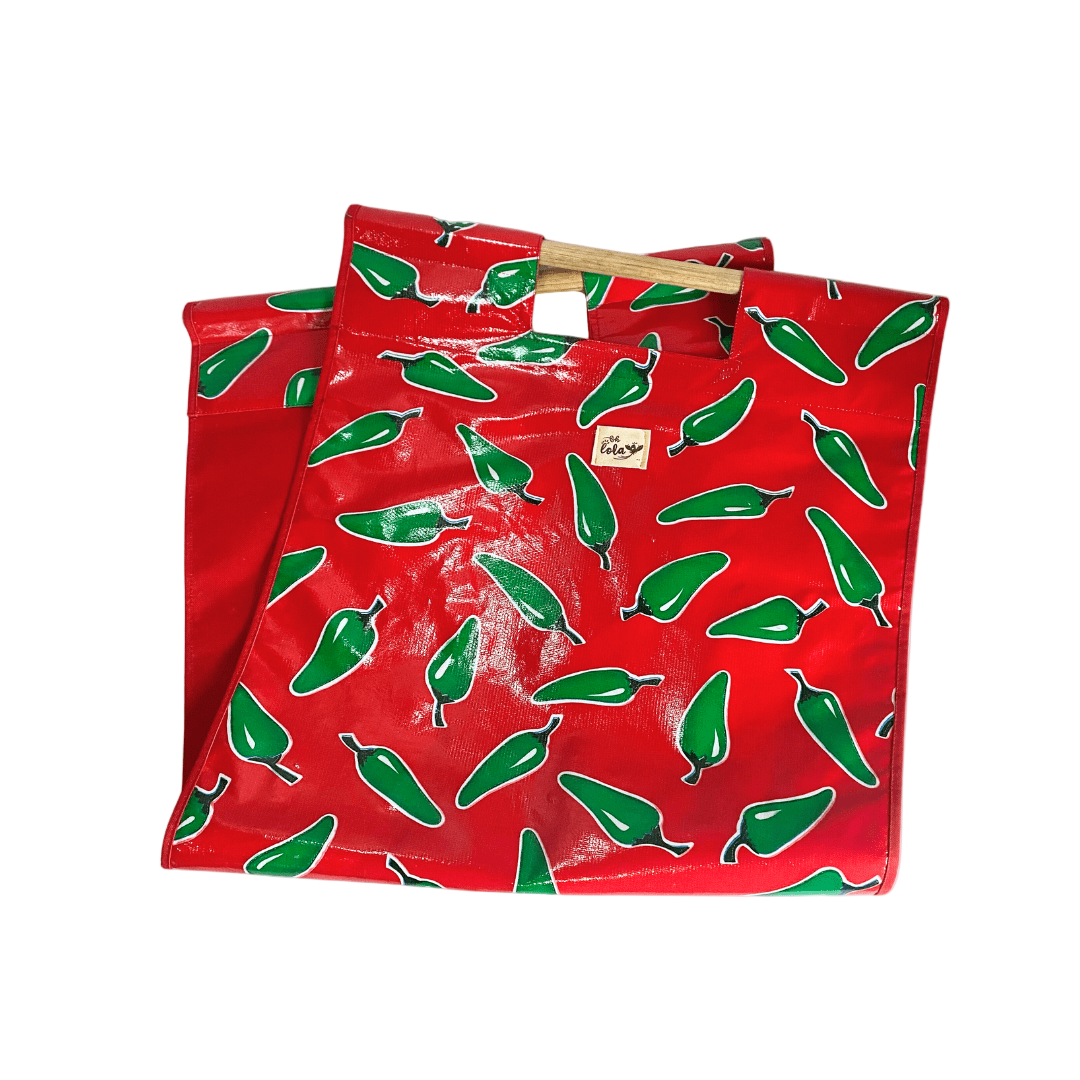 Red reusable tote bag with green chili pepper pattern and wooden handles