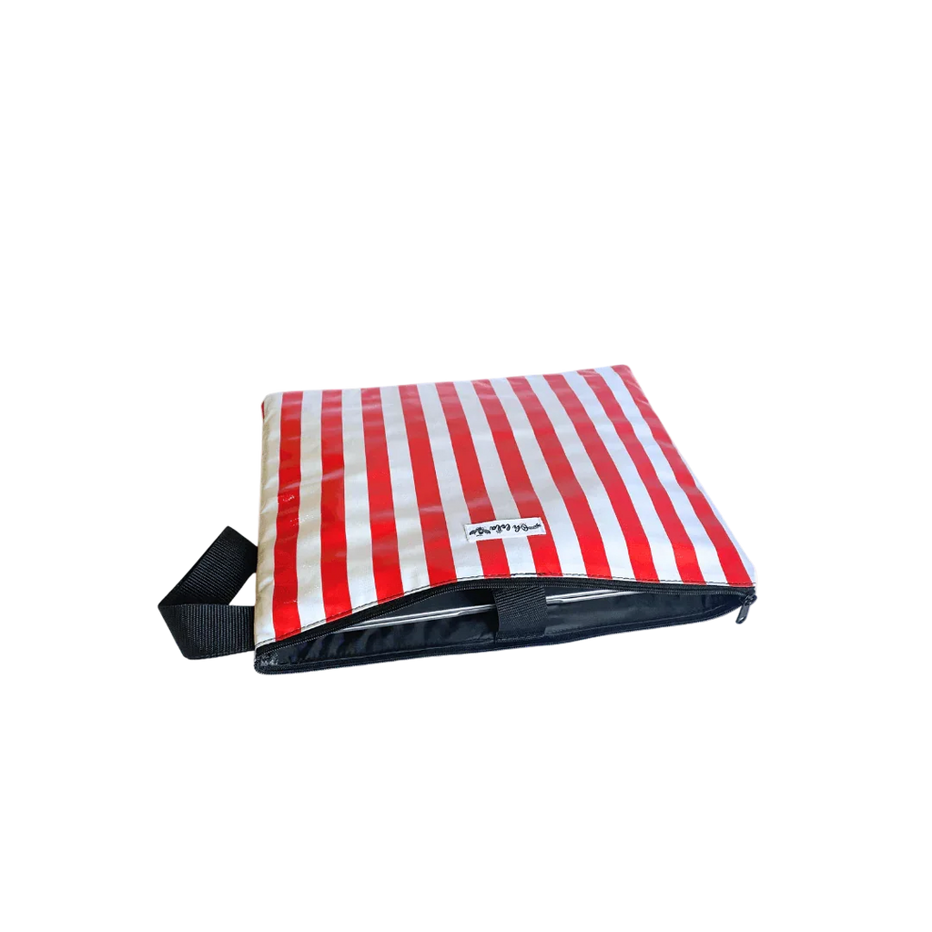 Red and white striped insulated lunch bag with zipper and black handle on white background