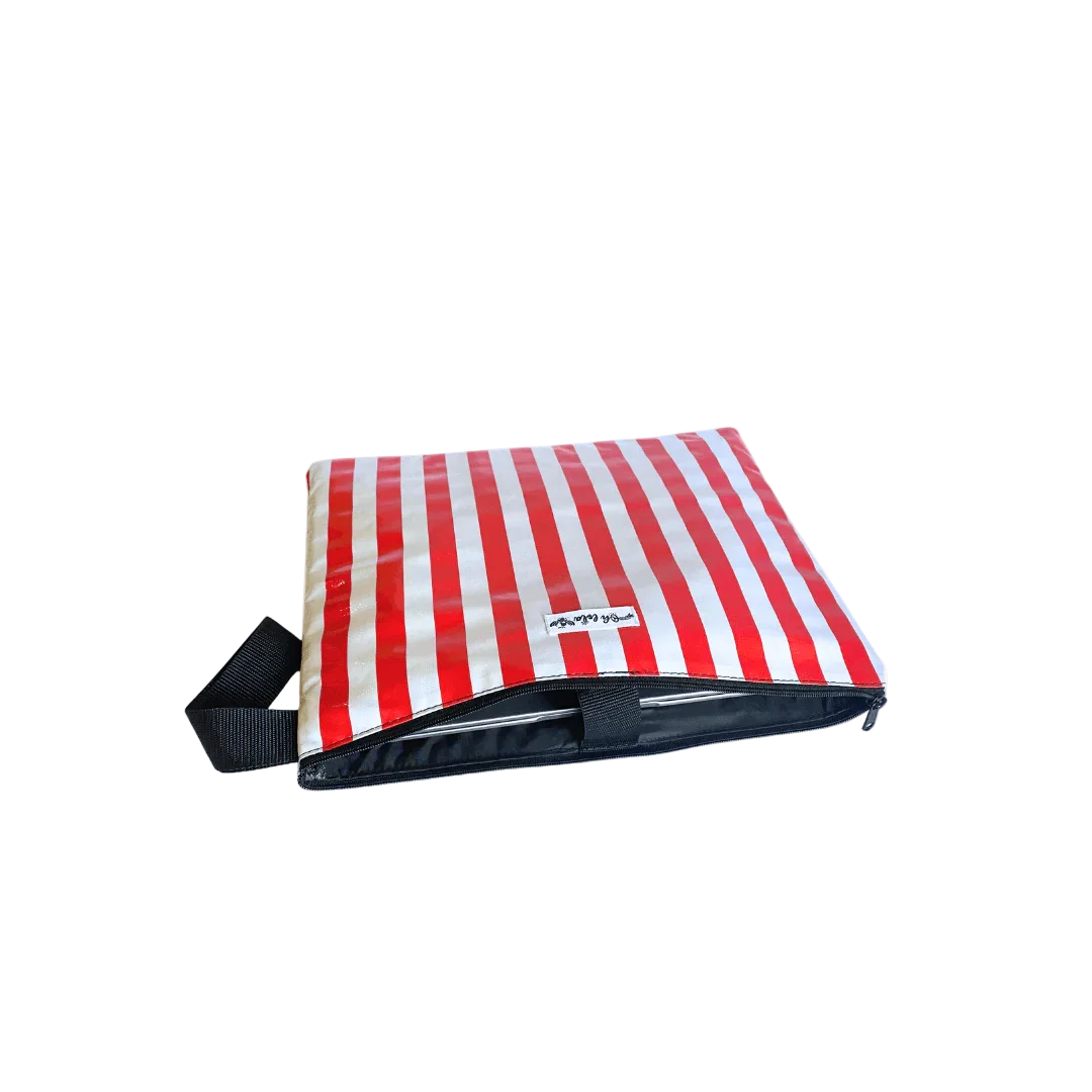 Red and white striped insulated lunch bag with zipper and black handle on white background