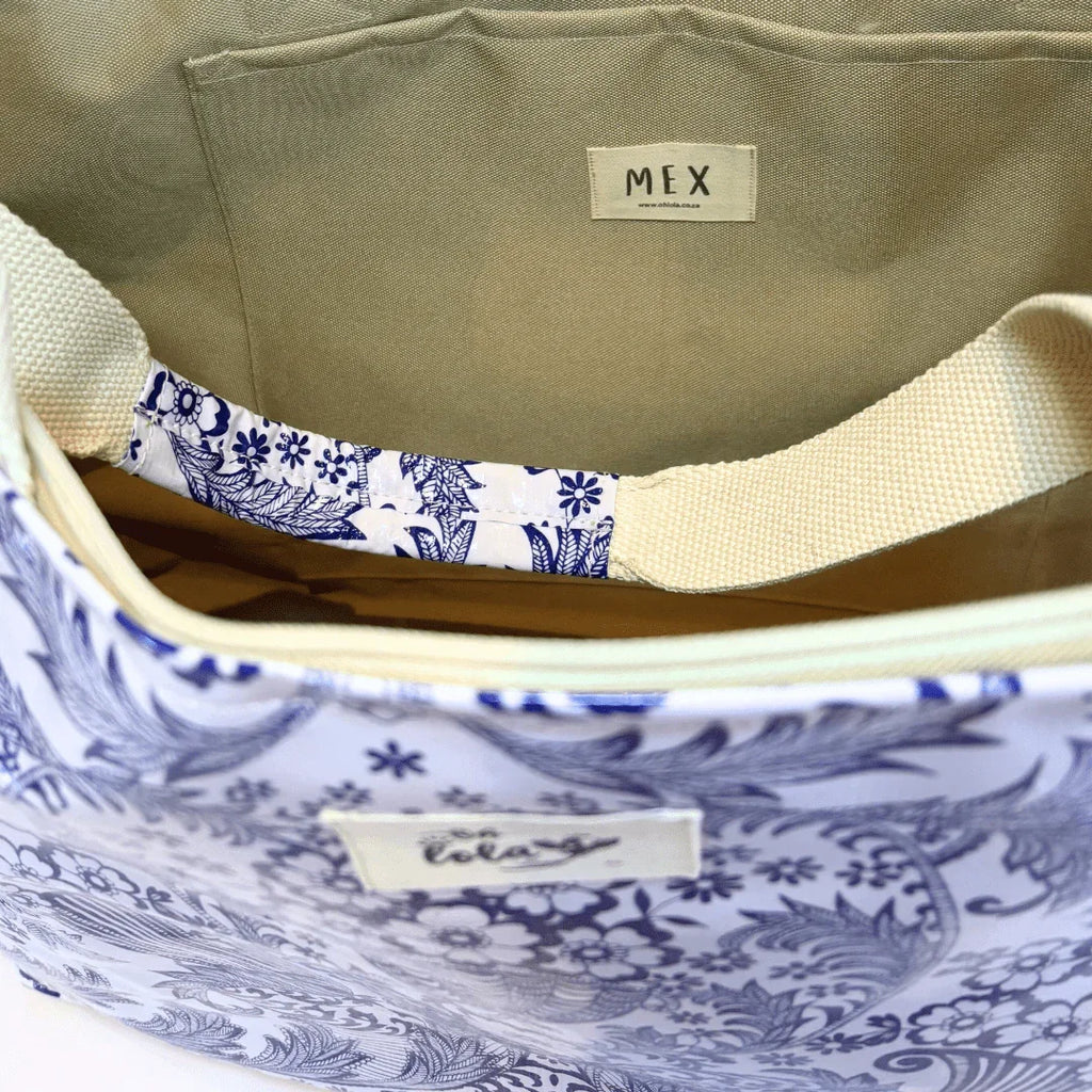 Open floral patterned tote bag with beige interior and white strap labeled MEX