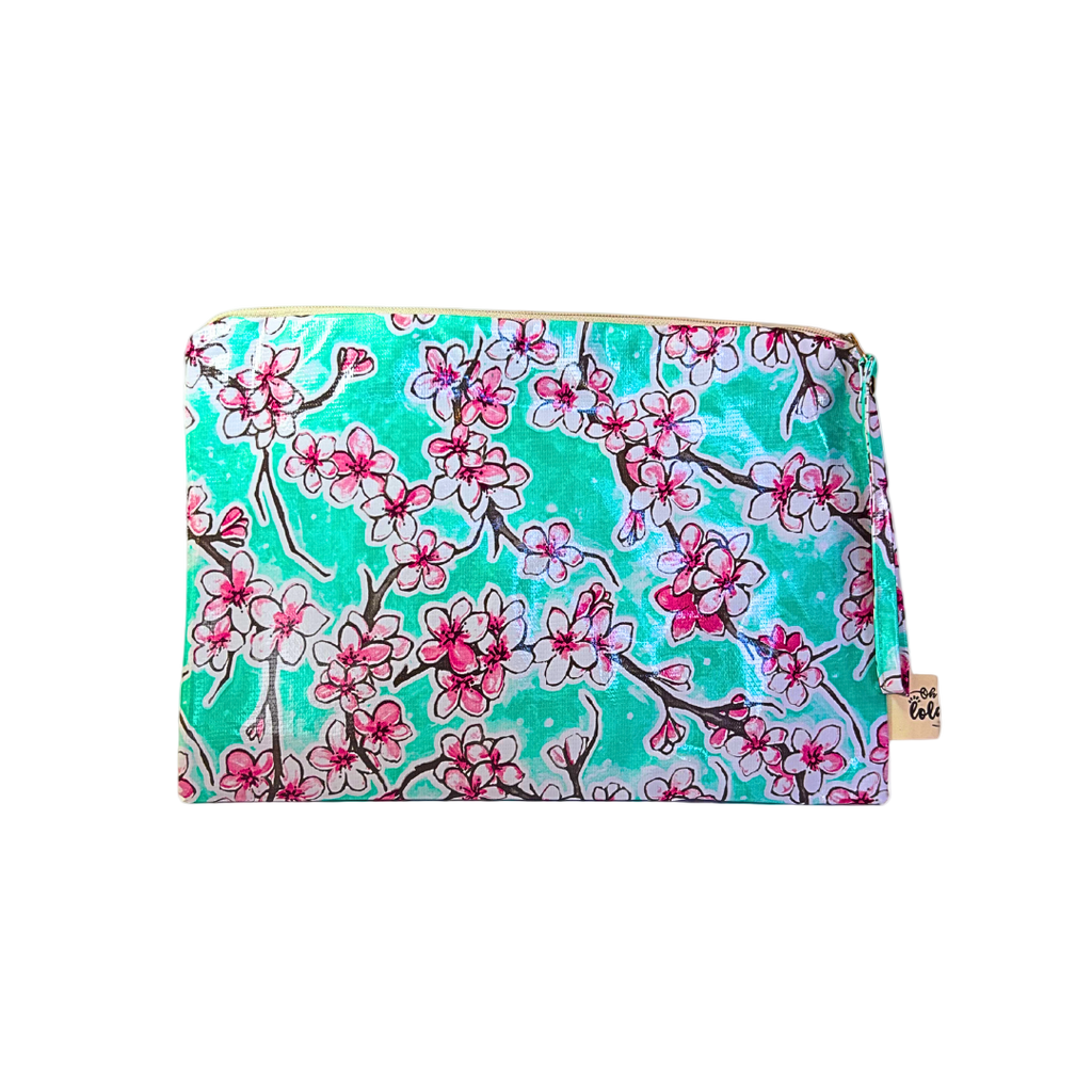 Floral patterned pouch with pink flowers on a teal background