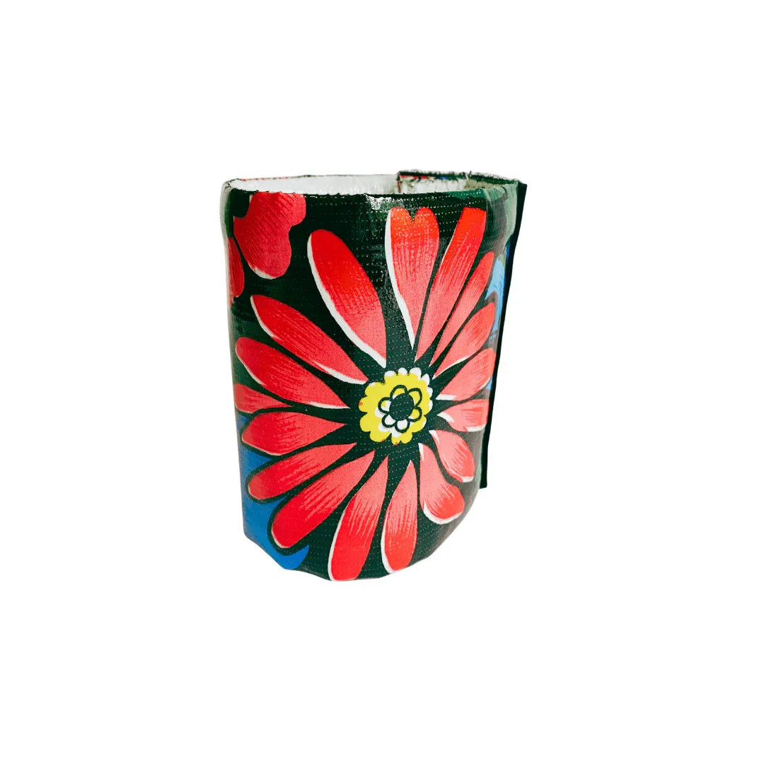 Colorful wristband with large red flower and yellow center on black background