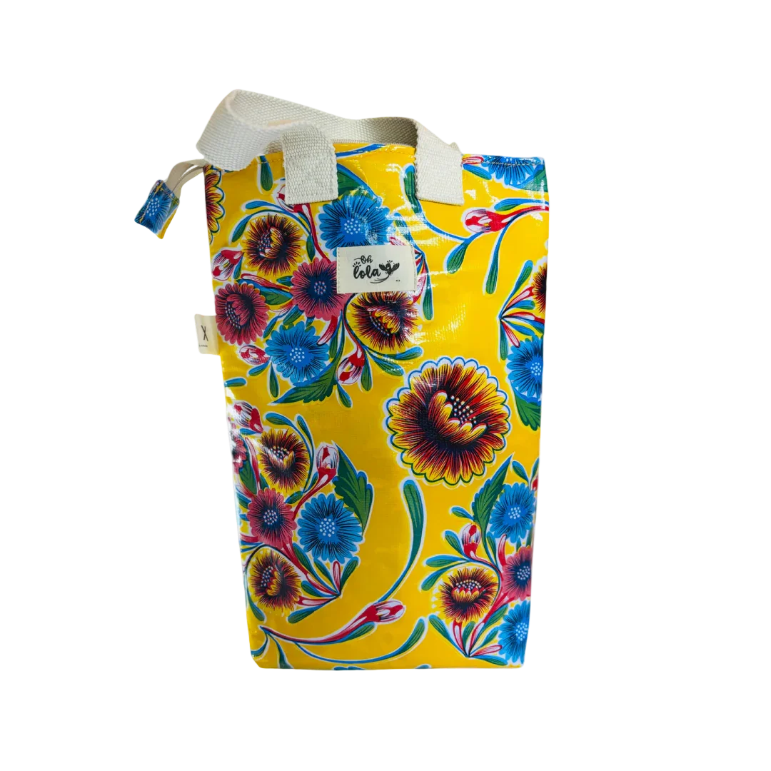 Yellow floral patterned waterproof tote bag with blue, red flowers and white handles