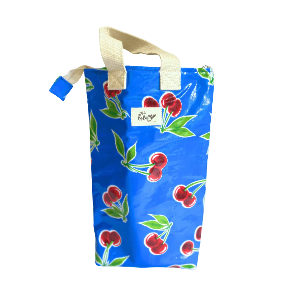 Blue tote bag with red cherry print and beige handles, featuring Oh Lola brand label