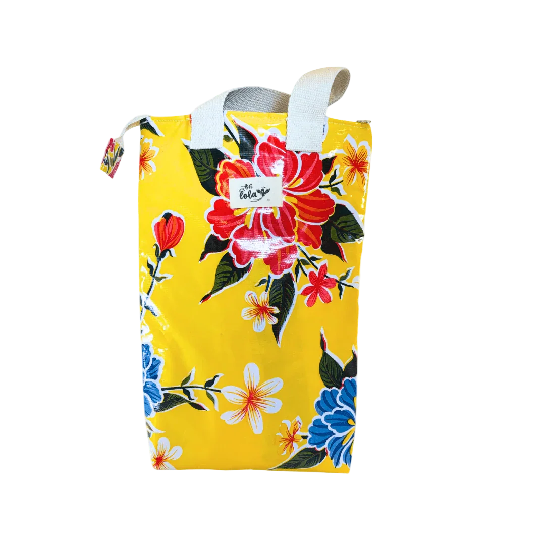 Yellow bag with vibrant red, blue, and white floral pattern and white handles