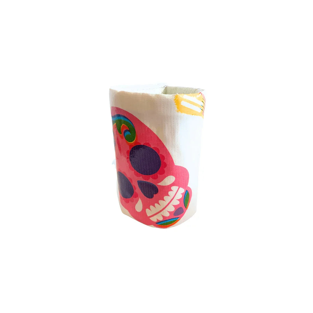 Roll of white napkins with colorful pink sugar skull design on a white background